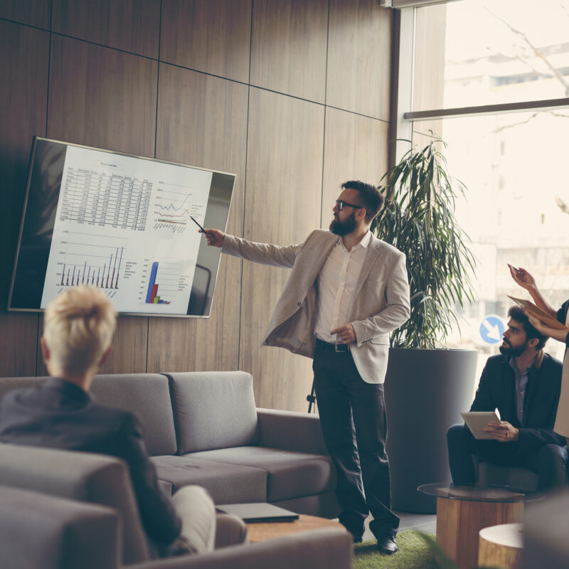 Business team on a morning briefing; business meeting and presentation in a modern office