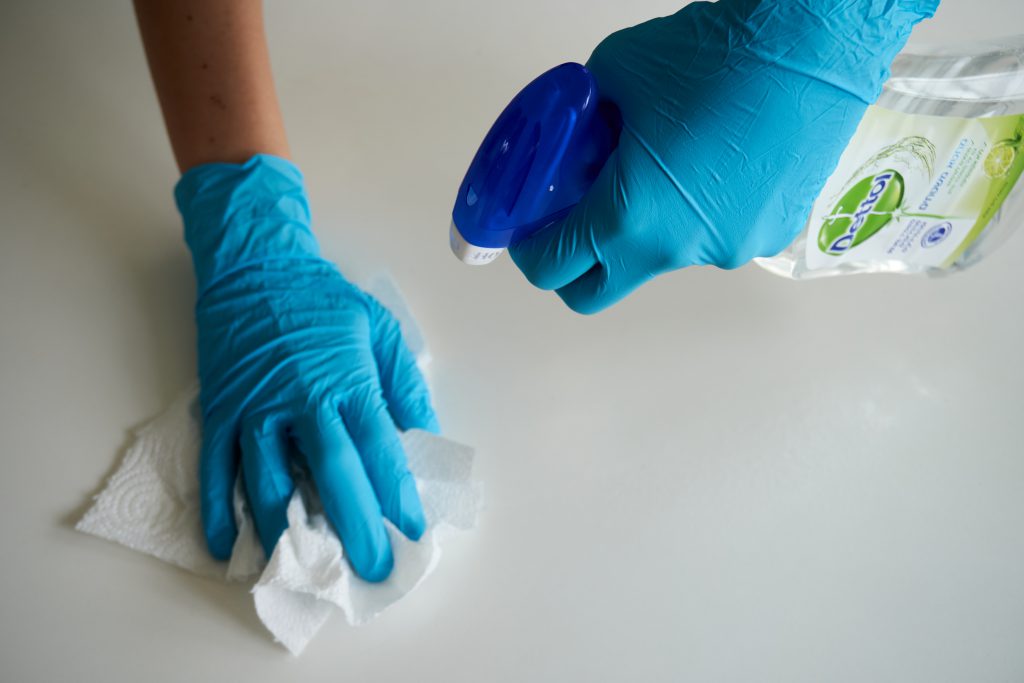 person-wearing-blue-gloves-cleaning-4021256