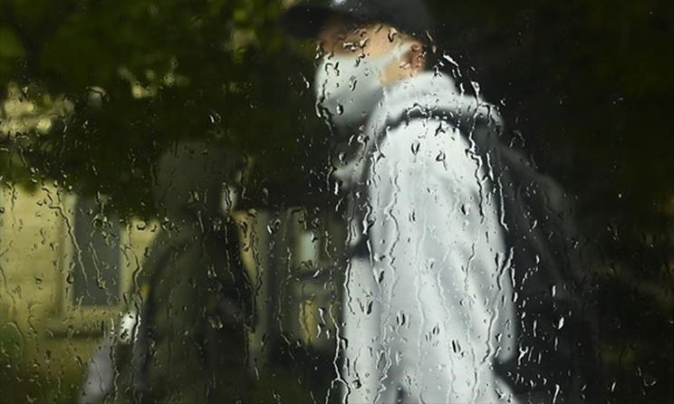 Man wearing mask in the rain
