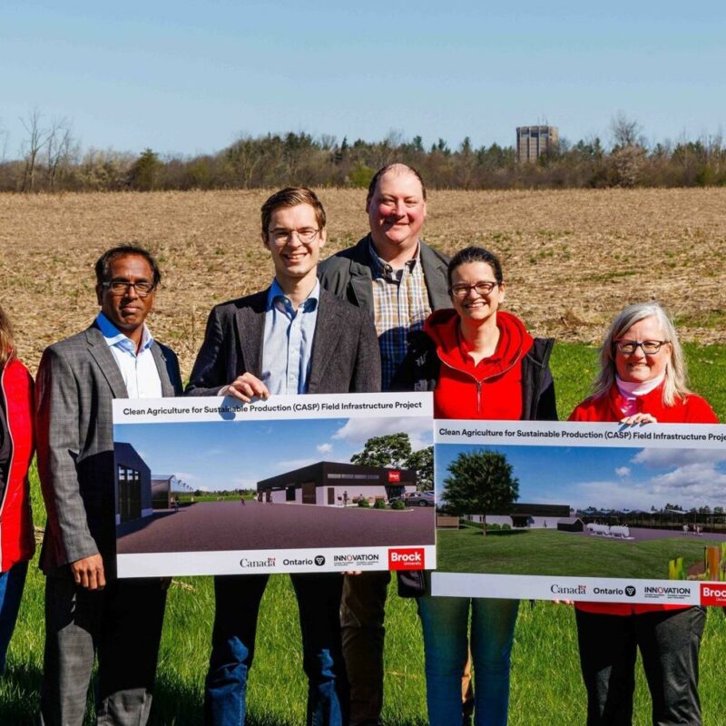 Gathered on the future site of the Brock University research farm are, from left, Brock president and vice-chancellor Lesley Rigg, Brock University Cool Climate Oenology and Viticulture Institute principal scientist Sudarsana Poojari, Niagara West MPP West Sam Oosterhoff, CCOVI researcher and assistant professor of biological sciences Jim Willwerth, interim vice-president external Meaghan Rusnell, CCOVI director Debbie Inglis and acting vice-president research Michelle McGinn.